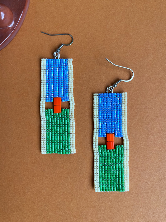 Sky Over Land beaded earrings with blue and green color-block design on a flat surface